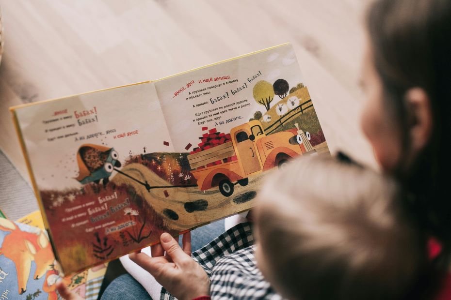 Mom reading a picture book to her toddler.